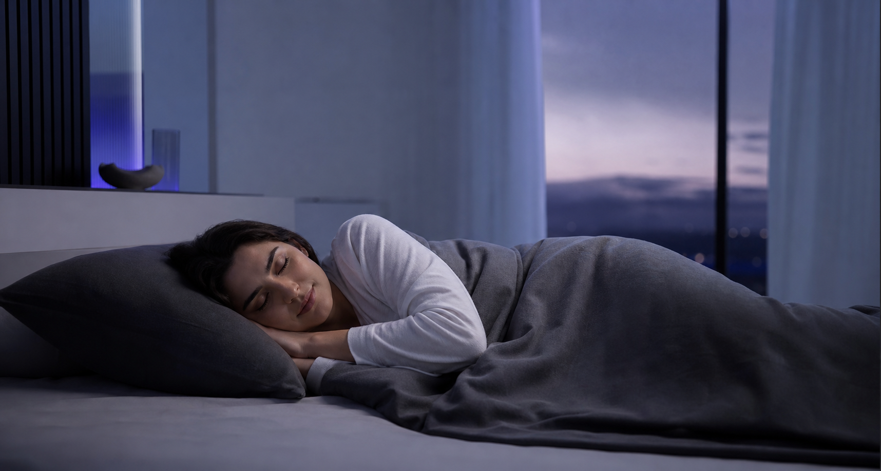 Woman sleeping peacefully in a modern bedroom at dawn